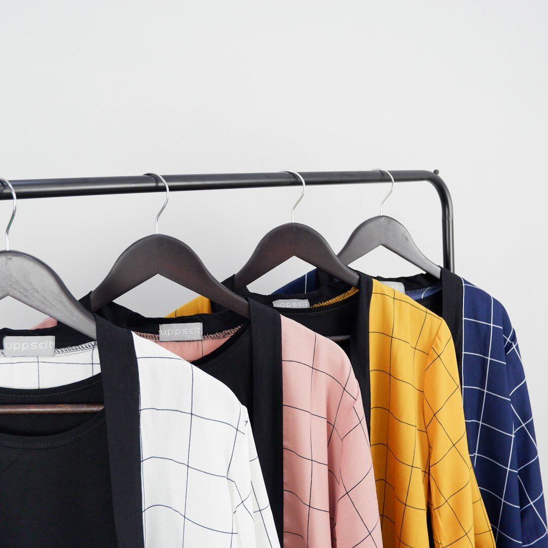 Neatly organized closet with folded clothes and storage boxes